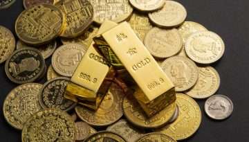 Coins, and gold bars scattered on a table